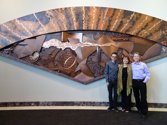 Tony bloom and family in front of FanFare Copper sculpture